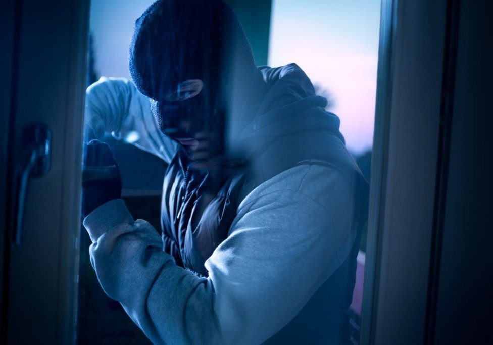 a burglar invading a house a burglar invading a house